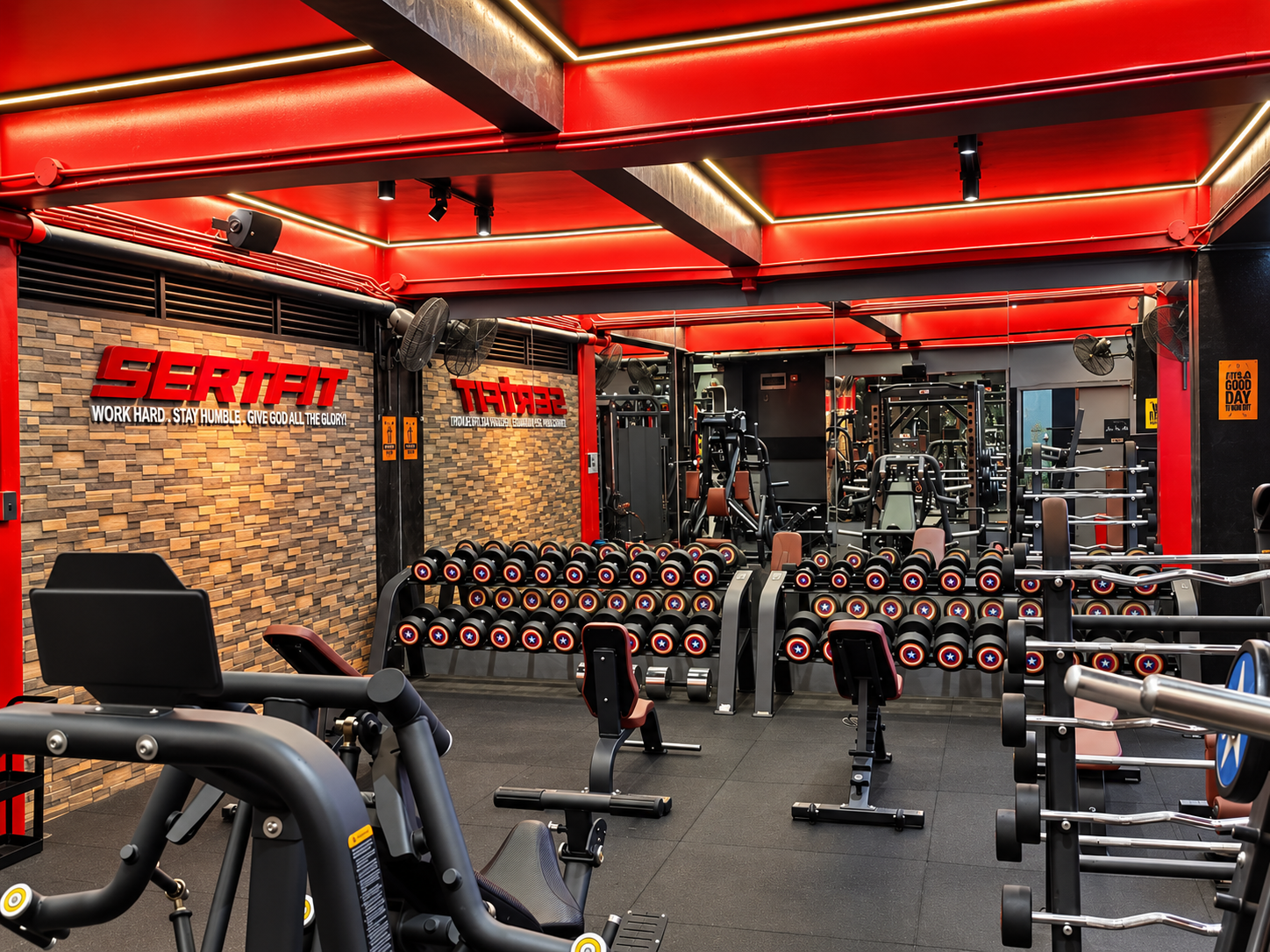 Strength floor with racks and free weights.